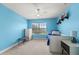 Charming blue bedroom with a twin bed, dresser, and a bright window at 1716 Wild Indigo Ter, Oviedo, FL 32766