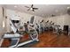 Well-equipped gym with modern cardio machines and hardwood floors at 1716 Wild Indigo Ter, Oviedo, FL 32766