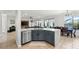 Open-concept kitchen with island, stainless steel appliances, and breakfast bar seating at 1716 Wild Indigo Ter, Oviedo, FL 32766