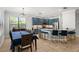 Modern open kitchen with marble countertops, stainless steel appliances, blue cabinets, and a dining area at 1716 Wild Indigo Ter, Oviedo, FL 32766