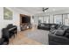 Bright and spacious living room with a large black leather couch and tile flooring at 1716 Wild Indigo Ter, Oviedo, FL 32766