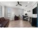 A well-lit office with a sofa, desk, and plenty of natural light at 1716 Wild Indigo Ter, Oviedo, FL 32766