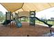 Community playground with slides and climbing structures with a sunshade over play area at 1716 Wild Indigo Ter, Oviedo, FL 32766