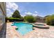 A refreshing backyard pool and integrated spa with a slide, brick patio, lush green hedges and lawn for privacy at 1716 Wild Indigo Ter, Oviedo, FL 32766