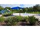 Community splash pad with playground featuring a sunshade, fountains, and landscaping at 1716 Wild Indigo Ter, Oviedo, FL 32766