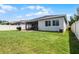Backyard with a well-maintained lawn and screened in patio at 17200 Gathering Place Cir, Clermont, FL 34711