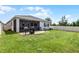 Spacious backyard with a patio, outdoor grill, and well-maintained lawn at 17200 Gathering Place Cir, Clermont, FL 34711