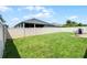 Grassy backyard with privacy fence and outdoor seating at 17200 Gathering Place Cir, Clermont, FL 34711