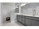 Modern bathroom features a tiled shower with glass door and double sink vanity at 17200 Gathering Place Cir, Clermont, FL 34711
