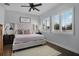 Bright primary bedroom boasts wood floors, large windows with shutters, and neutral colors at 17200 Gathering Place Cir, Clermont, FL 34711