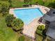 Large community pool with lounge chairs and palm trees at 17200 Gathering Place Cir, Clermont, FL 34711