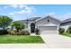 Charming single-story home with a well-manicured lawn and inviting curb appeal at 17200 Gathering Place Cir, Clermont, FL 34711