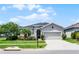 Beautiful one-story home with a lush front lawn and a charming facade at 17200 Gathering Place Cir, Clermont, FL 34711