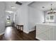 A welcoming foyer with wood floors, an arched entry and a decorative table creates a warm entrance at 17200 Gathering Place Cir, Clermont, FL 34711