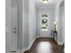 Bright foyer with hardwood floors, a glass front door, and neutral wall color at 17200 Gathering Place Cir, Clermont, FL 34711