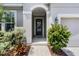 Inviting front entrance with a decorative door and landscaped surroundings at 17200 Gathering Place Cir, Clermont, FL 34711
