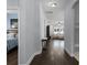 Open hallway with hardwood floors that connects to the living room and bedroom at 17200 Gathering Place Cir, Clermont, FL 34711