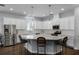Beautiful kitchen features a large island, stainless appliances, and pendant lighting at 17200 Gathering Place Cir, Clermont, FL 34711