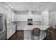 Well-appointed kitchen featuring white cabinets, subway tile backsplash, and quartz countertops at 17200 Gathering Place Cir, Clermont, FL 34711