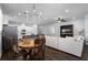 Open-concept living room, kitchen, and dining area boasts hardwood floors and an elegant chandelier at 17200 Gathering Place Cir, Clermont, FL 34711