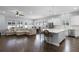Open floorplan showcases the living room, kitchen with island, and dining area at 17200 Gathering Place Cir, Clermont, FL 34711