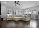 Spacious living room featuring hardwood floors and natural lighting from the windows at 17200 Gathering Place Cir, Clermont, FL 34711