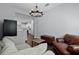 Relaxing living room with hardwood floors, chandelier and view into the spacious kitchen at 17200 Gathering Place Cir, Clermont, FL 34711