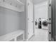 Mud room with a bench and coat hooks that leads to the laundry room at 17200 Gathering Place Cir, Clermont, FL 34711