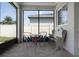 Enclosed patio with seating, a small table and view to the backyard at 17200 Gathering Place Cir, Clermont, FL 34711