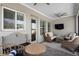 Screened in patio featuring wicker furniture and an outdoor television at 17200 Gathering Place Cir, Clermont, FL 34711