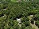 Aerial view of tree covered property with a home accented by a gold star at 183 Parsons Rd, Longwood, FL 32779