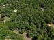 Aerial view of a tree covered property, the homes accented with gold stars at 183 Parsons Rd, Longwood, FL 32779