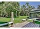 A spacious backyard featuring a deck, lush green grass, and the exterior of a home with a screened-in porch at 183 Parsons Rd, Longwood, FL 32779