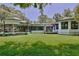 Expansive backyard with lush green lawn, screened porch, and inviting outdoor seating area at 183 Parsons Rd, Longwood, FL 32779