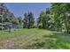 Expansive backyard with lush grass and mature trees offering a serene and private outdoor space at 183 Parsons Rd, Longwood, FL 32779
