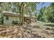 View of the backyard featuring a wooden deck, screened-in porch, and lush greenery at 183 Parsons Rd, Longwood, FL 32779