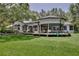 Wide view of backyard featuring lawn, screened porch, and expansive deck at 183 Parsons Rd, Longwood, FL 32779