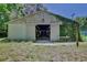 Exterior view of a barn with an open entrance, showcasing its potential for various uses on a spacious property at 183 Parsons Rd, Longwood, FL 32779
