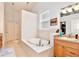 Luxurious bathroom with a large soaking tub, tile flooring, and ample vanity space at 183 Parsons Rd, Longwood, FL 32779