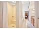 Bright bathroom featuring tiled shower with a seat and tiled floors flowing to vanity at 183 Parsons Rd, Longwood, FL 32779