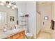 Bright bathroom features a single vanity, neutral countertops, and modern light fixtures at 183 Parsons Rd, Longwood, FL 32779