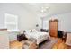 Comfortable bedroom featuring wood floors, a ceiling fan, and a cozy bed with stairs for pets at 183 Parsons Rd, Longwood, FL 32779