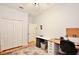Large bedroom features wood floors, a ceiling fan, and an expansive desk area at 183 Parsons Rd, Longwood, FL 32779