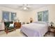 Cozy bedroom with natural light, two windows, ceiling fan, and comfortable seating area at 183 Parsons Rd, Longwood, FL 32779
