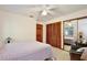 Spacious bedroom with ceiling fan, closet with mirror doors, and comfortable seating area at 183 Parsons Rd, Longwood, FL 32779
