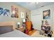 Cozy bedroom with posters, a guitar, and a view of the closet and door at 183 Parsons Rd, Longwood, FL 32779