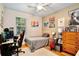 Trendy bedroom with a desk, guitar and posters on the wall at 183 Parsons Rd, Longwood, FL 32779