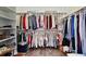 Walk-in closet with custom storage, wood floors, and clothing neatly organized at 183 Parsons Rd, Longwood, FL 32779