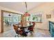 Inviting dining room featuring a custom chandelier and views of the outdoors at 183 Parsons Rd, Longwood, FL 32779