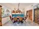 Bright dining area with a large window, unique lighting, and tile flooring at 183 Parsons Rd, Longwood, FL 32779